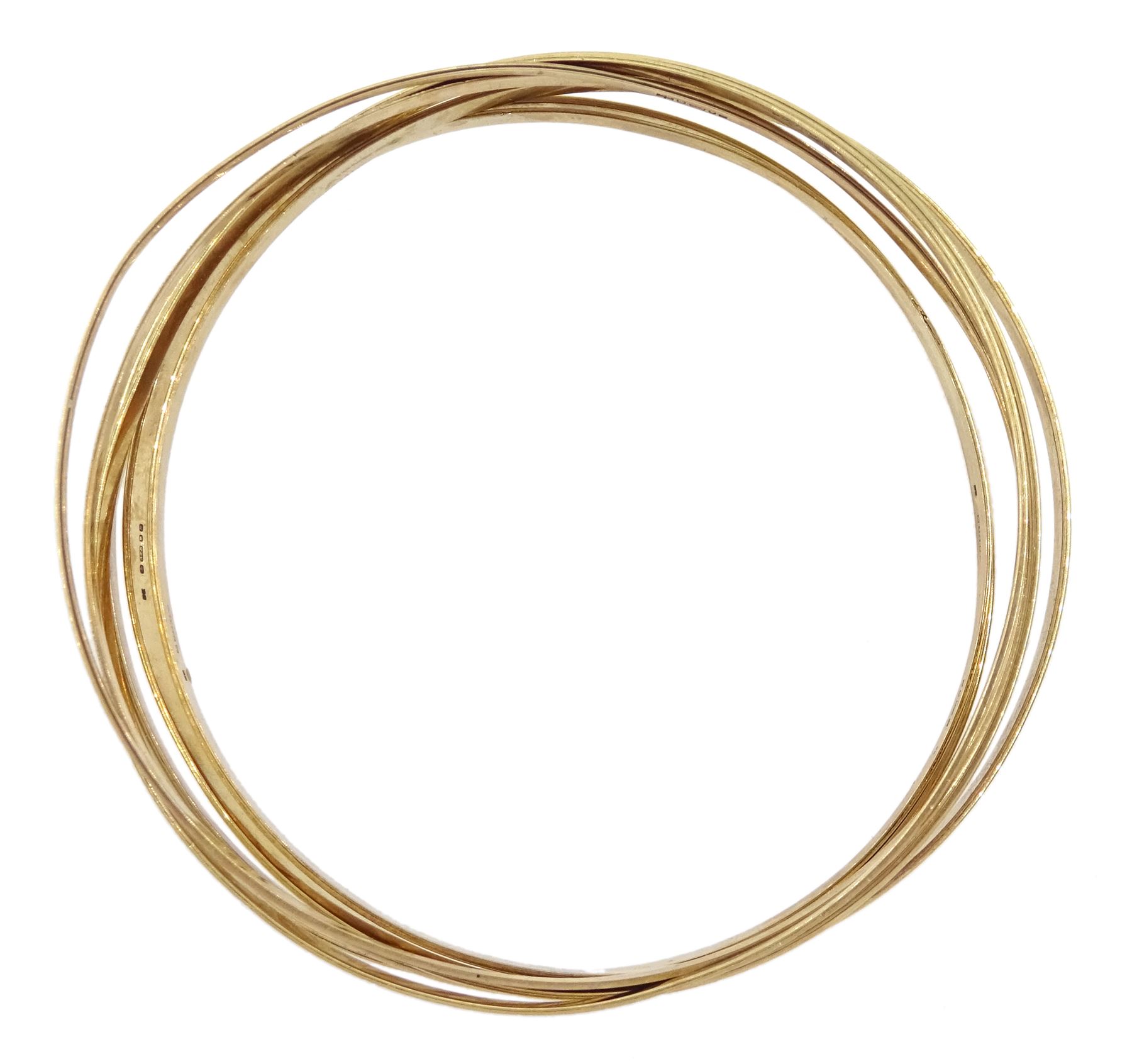 Seven 9ct gold bangles, with engraved decoration, all hallmarked