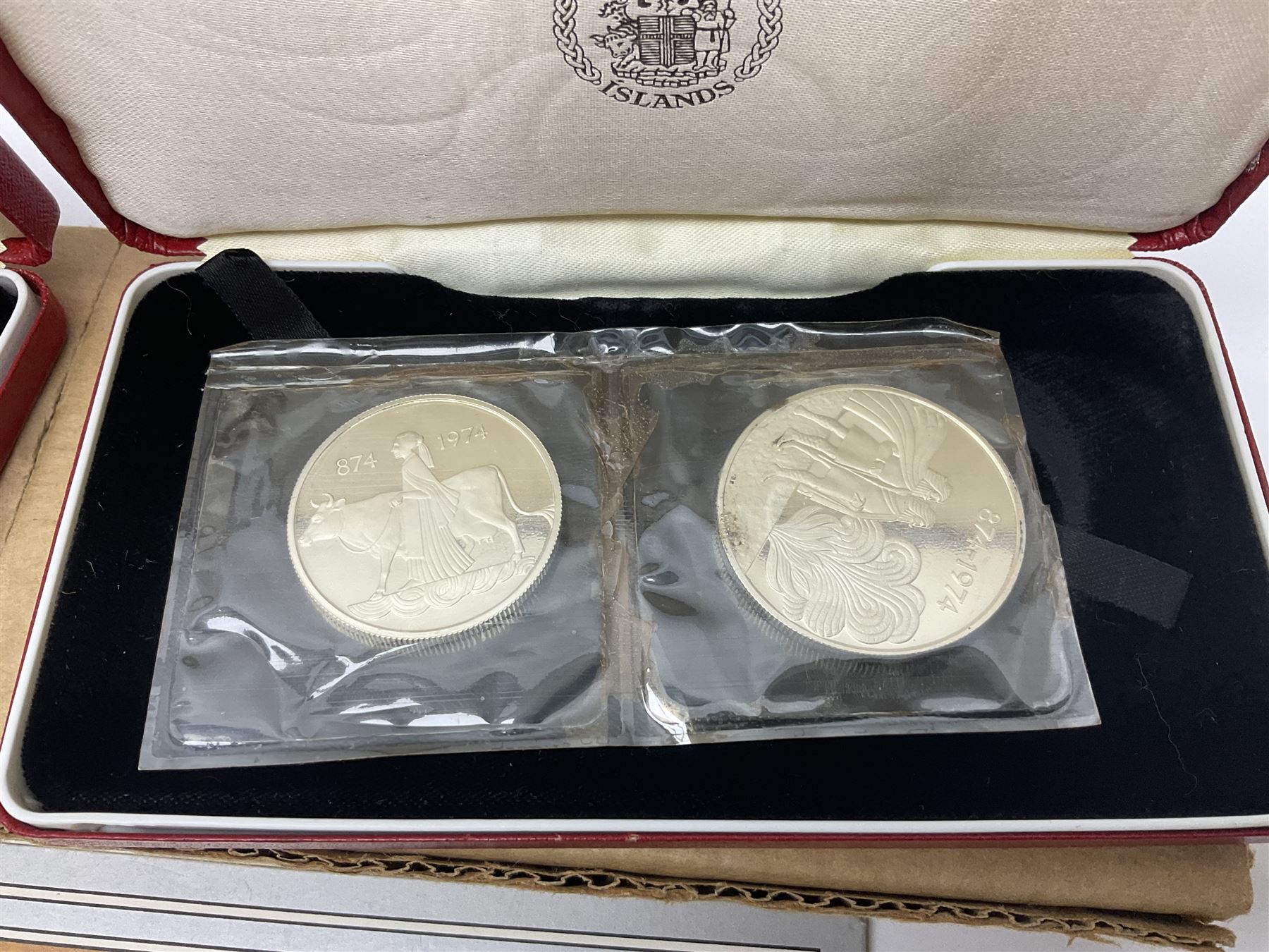 Coins including two King George VI 1951 Festival of Britain crowns each in green case, various other commemorative crowns, two Iceland '874-1974' two coin sets both in original red cases etc