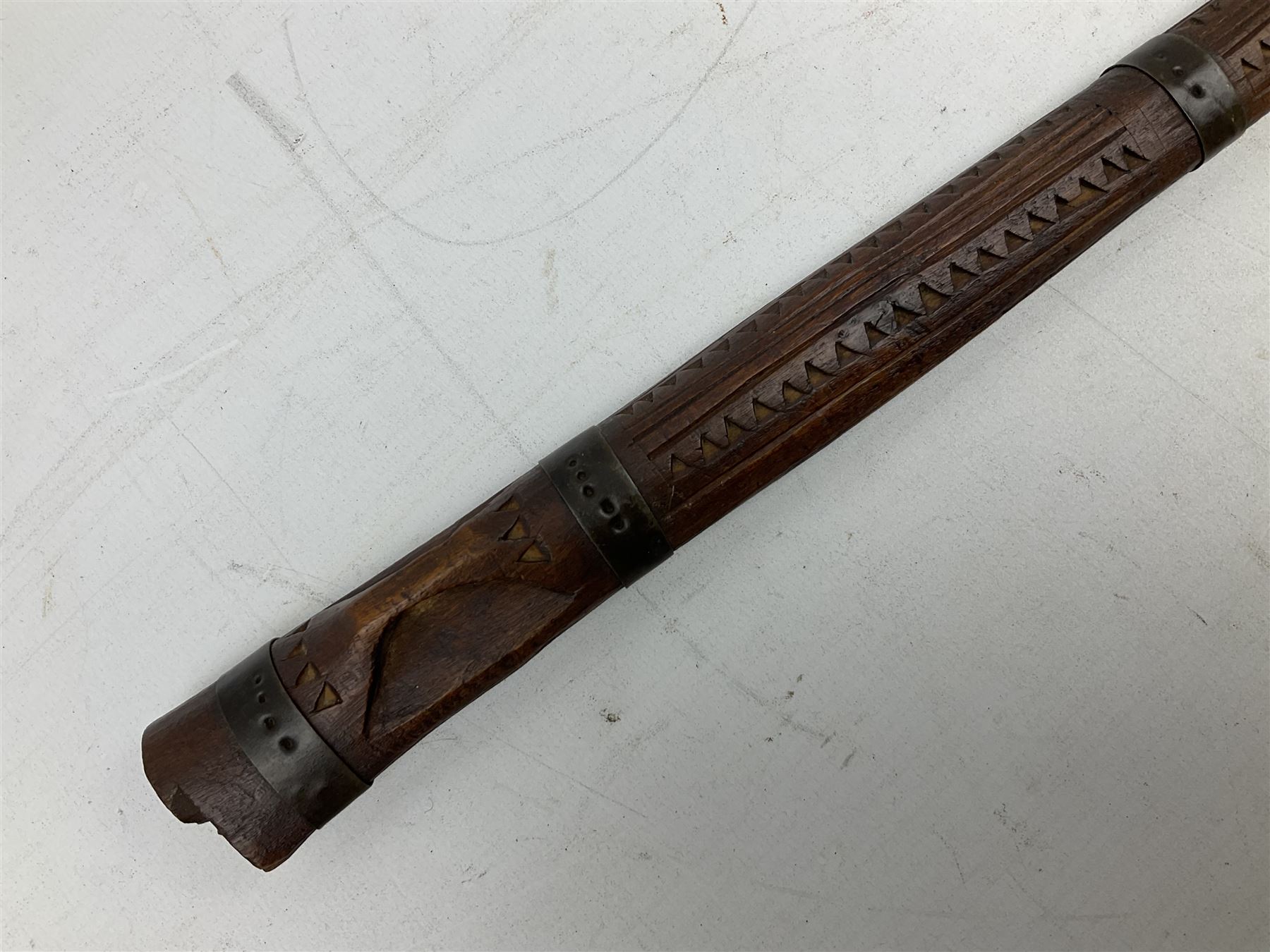 19th century Algerian Flyssa long knife, the 34cm single edged pointed decorative blade inset with yellow metal, chased brass grip with pommel as the snout of a stylised animal and carved hardwood scabbard L45cm overall