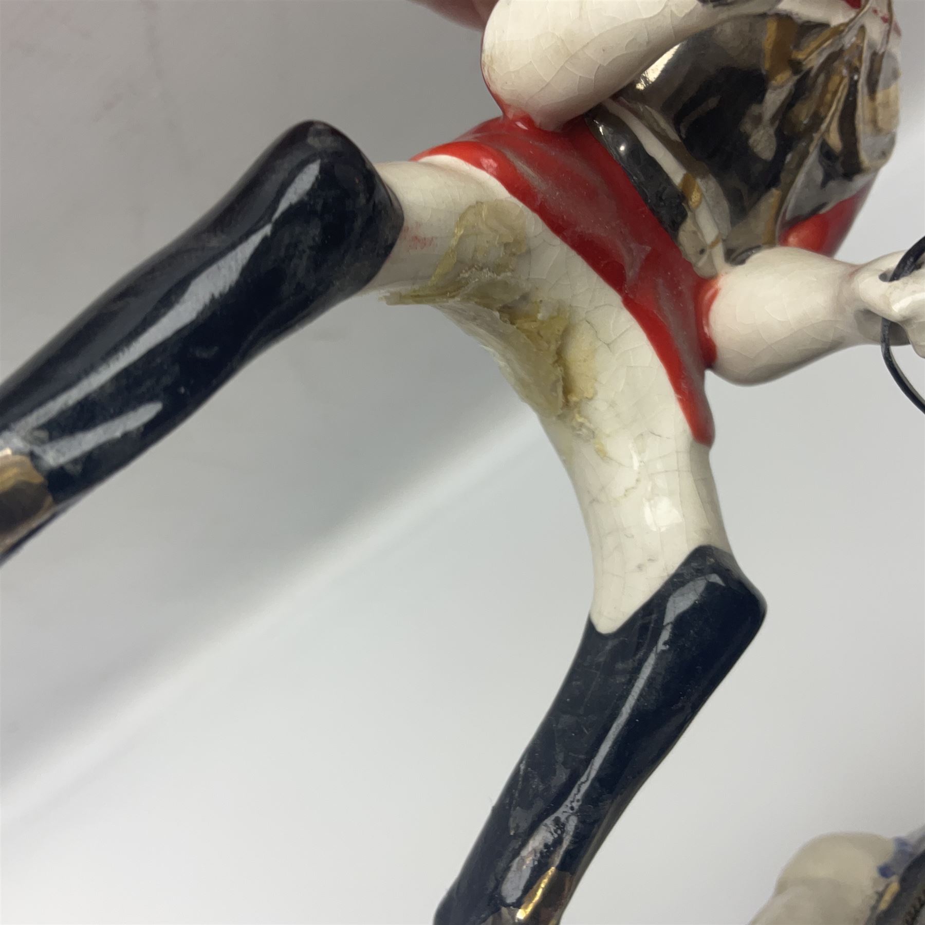 Mounted Lifeguard upon a black horse, in the style of Beswick, upon a wooden plinth, H31cm