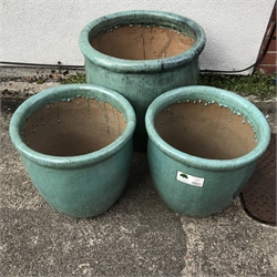 Three graduating teal glazed terracotta pots, H51cm (max)