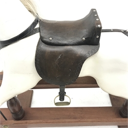 20th century carved and painted wood rocking horse, leather saddle and reins, stirrups, trestle base, L156cm, H121cm