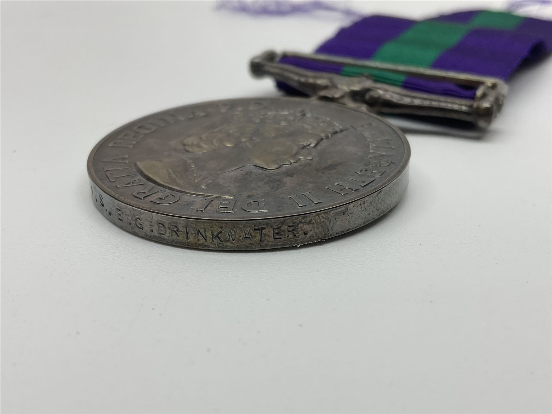 Collection of WW2 and police medals c.1933-1955, awarded to Eric Drinkwater comprising 1939-45 War Medal, Defence Medal, 1939-45 Star and Burma Star, on wearing bar; 1918-62 General Service Medal with Cyprus clasp to P.S. E.G. Drinkwater; boxed; Police Long Service and Good Conduct Medal to Const. Eric C. Drinkwater; cased; Royal Life Saving Society bronze medal to E.C. Drinkwater July 1933; boxed; and George V 1937 coronation medallion; boxed.