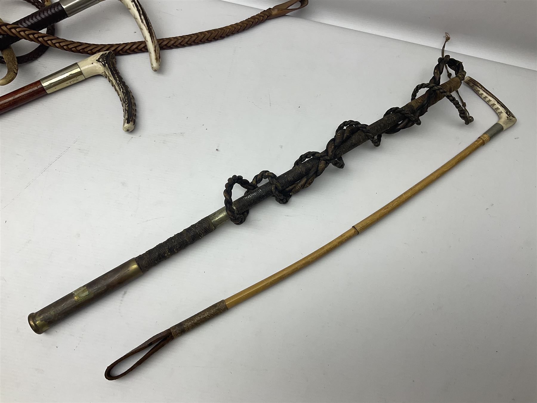 Collection of hunting crops and riding whips, including horn handle examples with silver cuffs