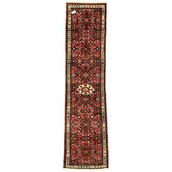  Persian red ground runner, decorated with large Herati motifs and shaped central medallion, the guarded border decorated with repeating heart motifs