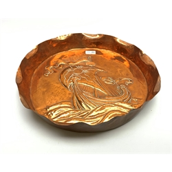Newlyn School style large circular copper dish, the raised rim with crimped edge and repousse study of a Viking long ship in a rough sea, un,arked, D41cm