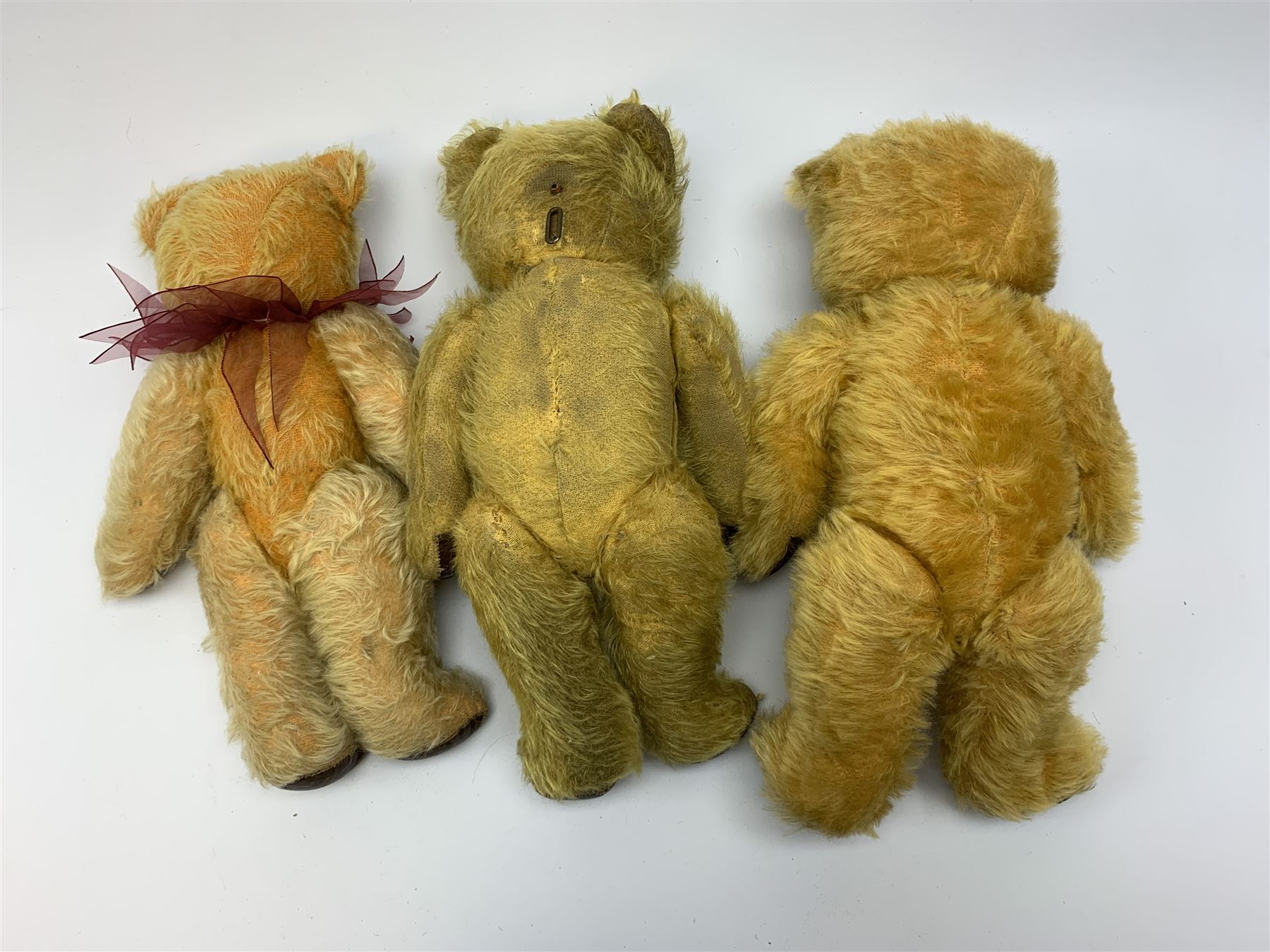 Two Irish Tara 'Laughing' bears c1950s each with mechanical opening mouth, one operated by sliding button to the back of the head, the other with squeeze and squeak action, and another Tara bear with jointed head, closed mouth and growler mechanism; all with plush body, glass eyes and vertically stitched nose and jointed limbs with rexine covered pads, largest H15