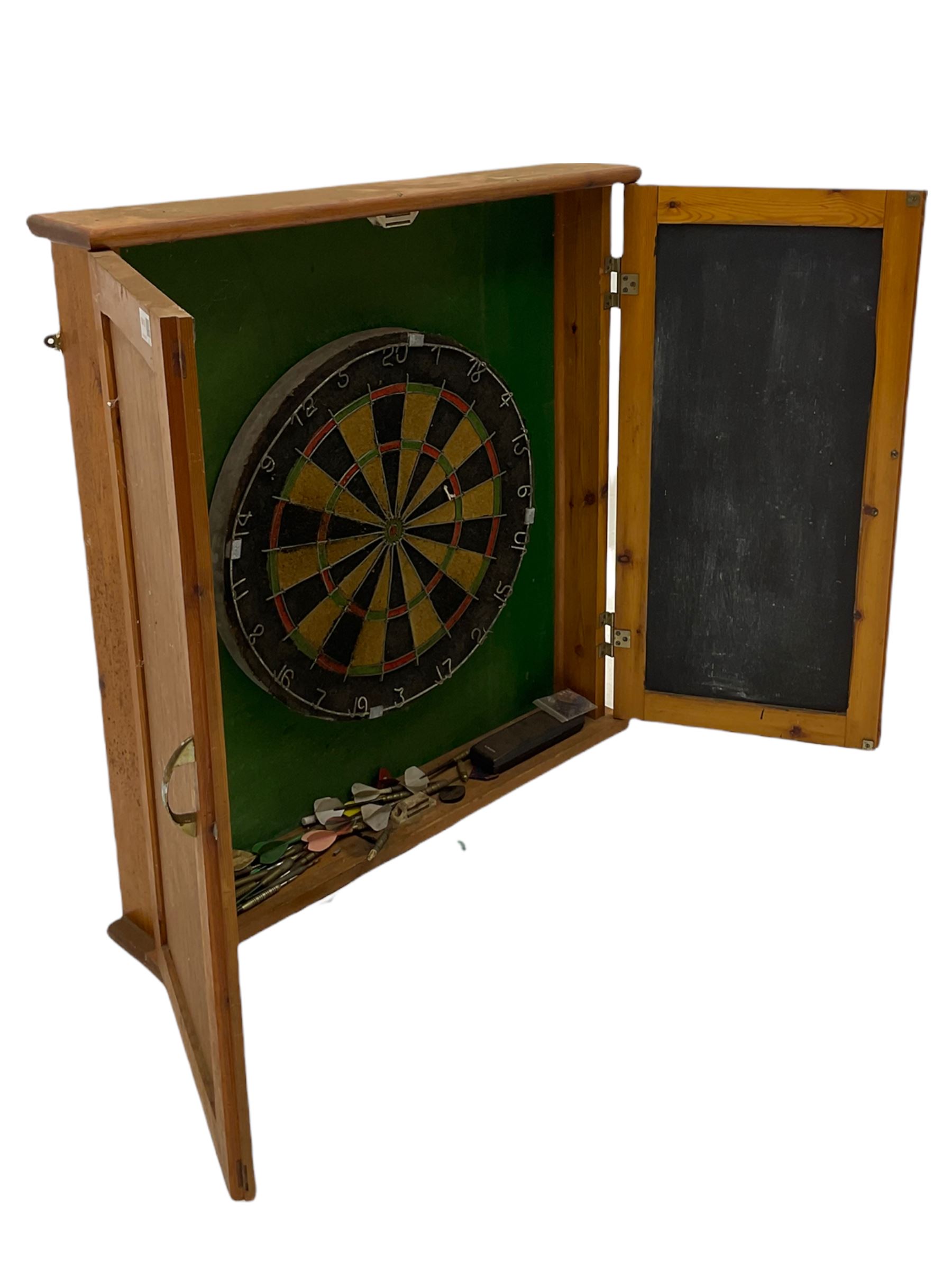 Dart board in wooden cabinet