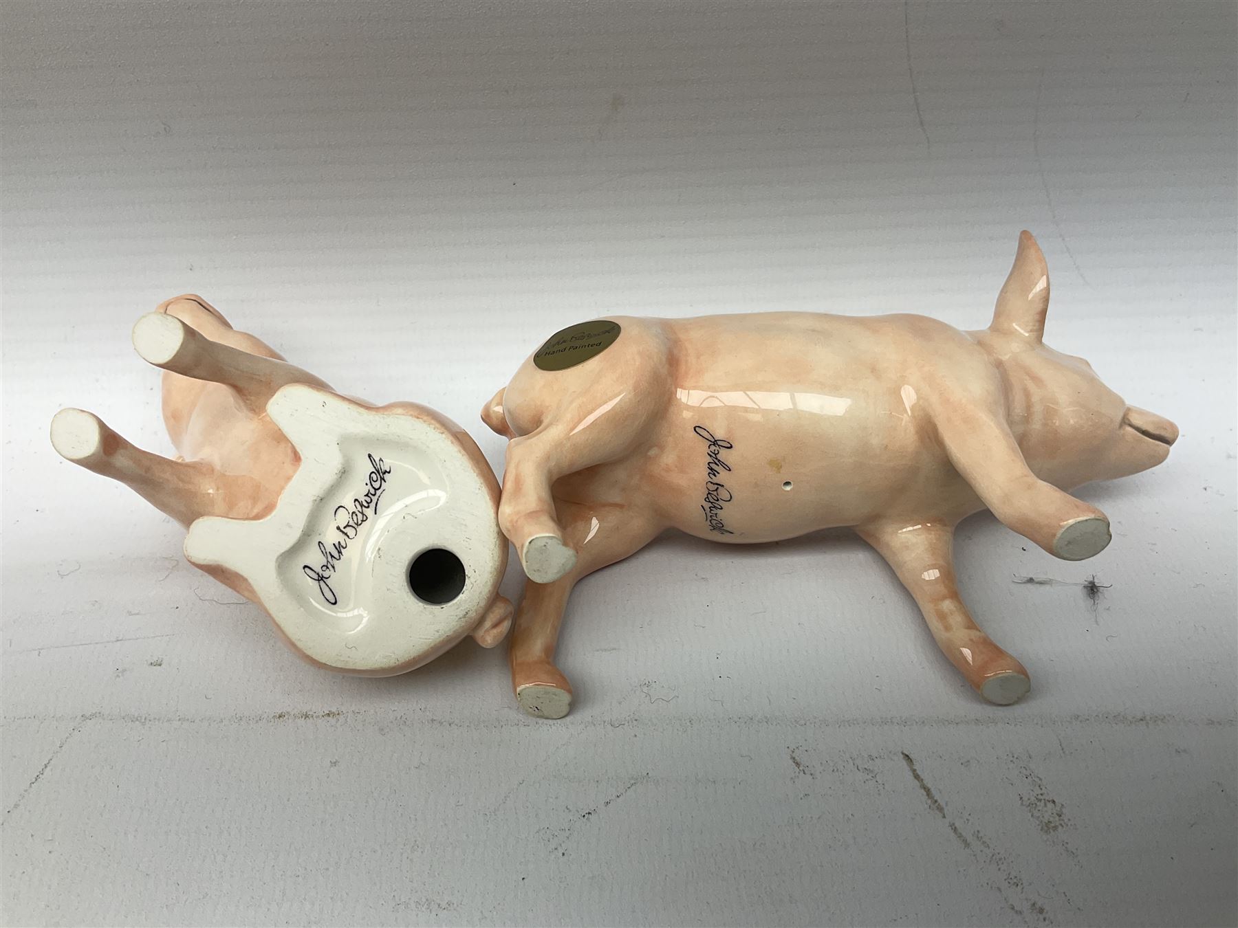Collection of Beswick pig figures, to include John Beswick Little Likeables ‘Hide and Sleep’, white boar pig and John Beswick trio of pigs, all marked beneath (5)