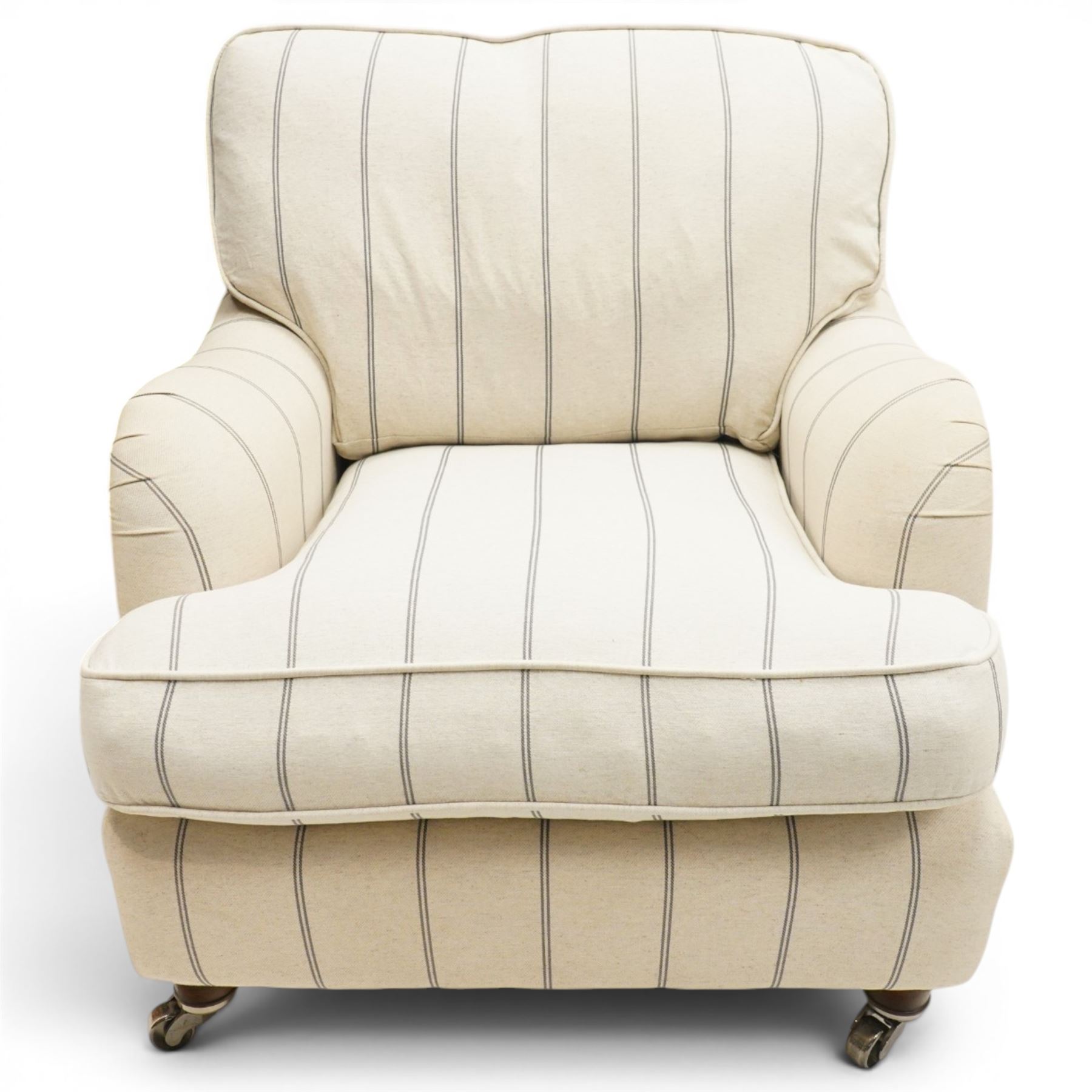 Pair of 20th century Howard shape armchairs, deep seat armchairs in cream and grep striped upholstery, raised on dark supports terminating in front castors