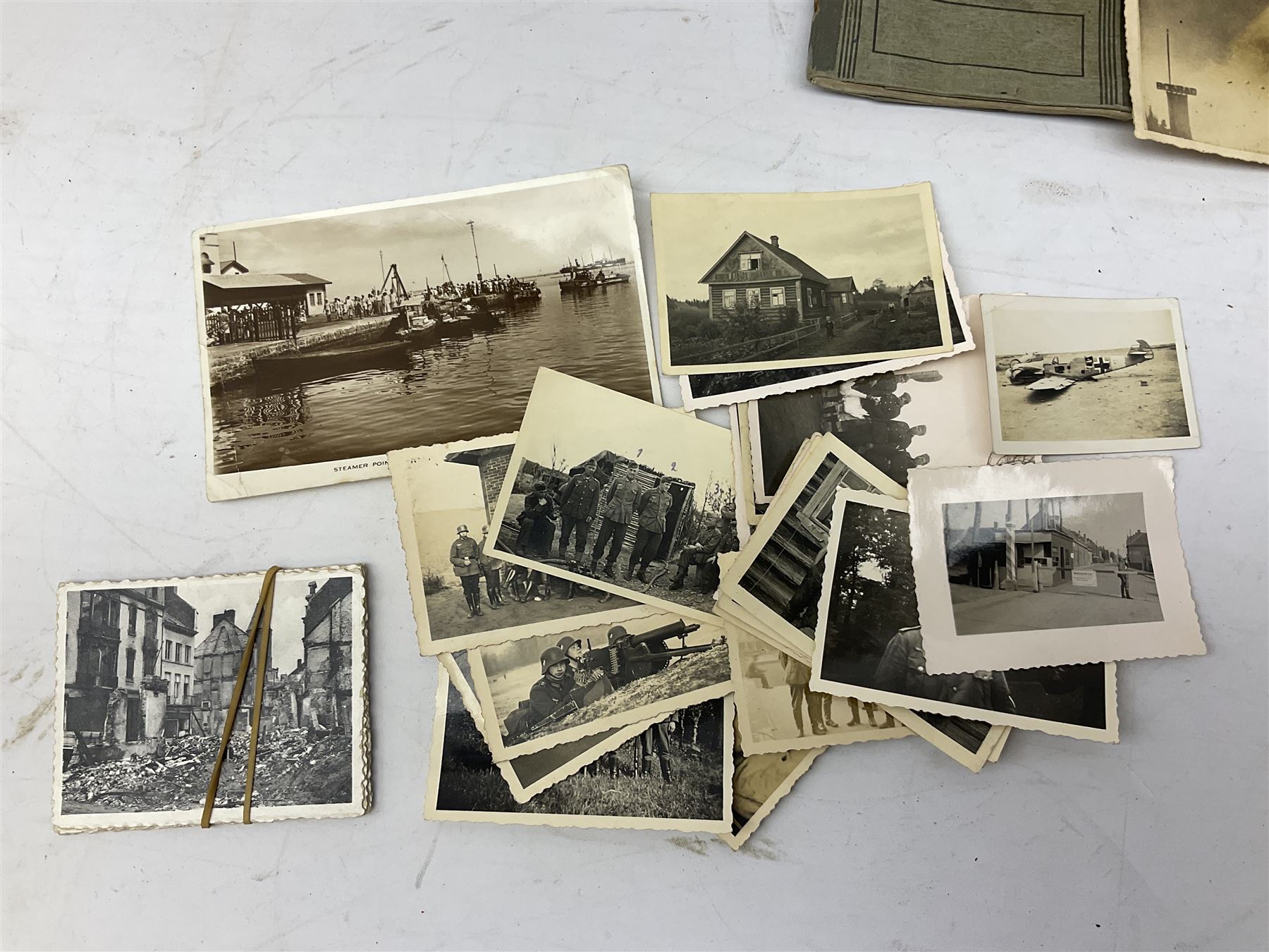 WW2 German War Pass (Wehrpass) identification paperwork for Walter Fensterseifer 2nd type booklet dated 8/6/1940, with signed photo of recipient in civilian suit. Born 31st January 1921. Numerous entries; together with quantity of small private photographs of German soldiers; One Million mark banknote 1923; 30th Corps in Germany booklet with Formation badge; and other WW2 paper ephemera