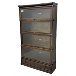 Globe Wernicke - stacking sectional library bookcase, over four glazed up-and-over doors, each bearing original makers mark, on moulded plinth base with inbuilt drawer
