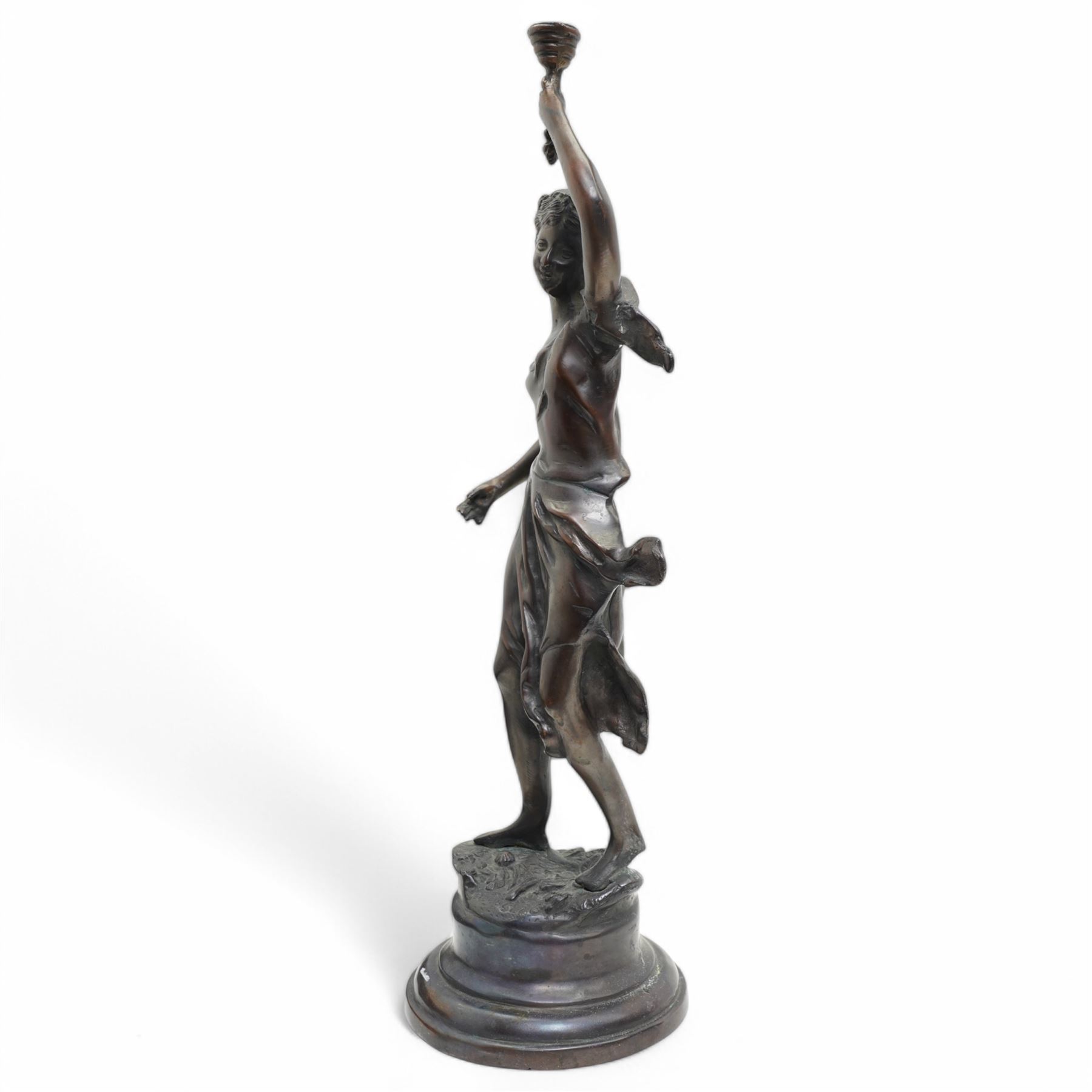 After Victor Rousseau (1865-1954)  - bronze sculpture of a lady holding aloft a torch and on circular base H50cm