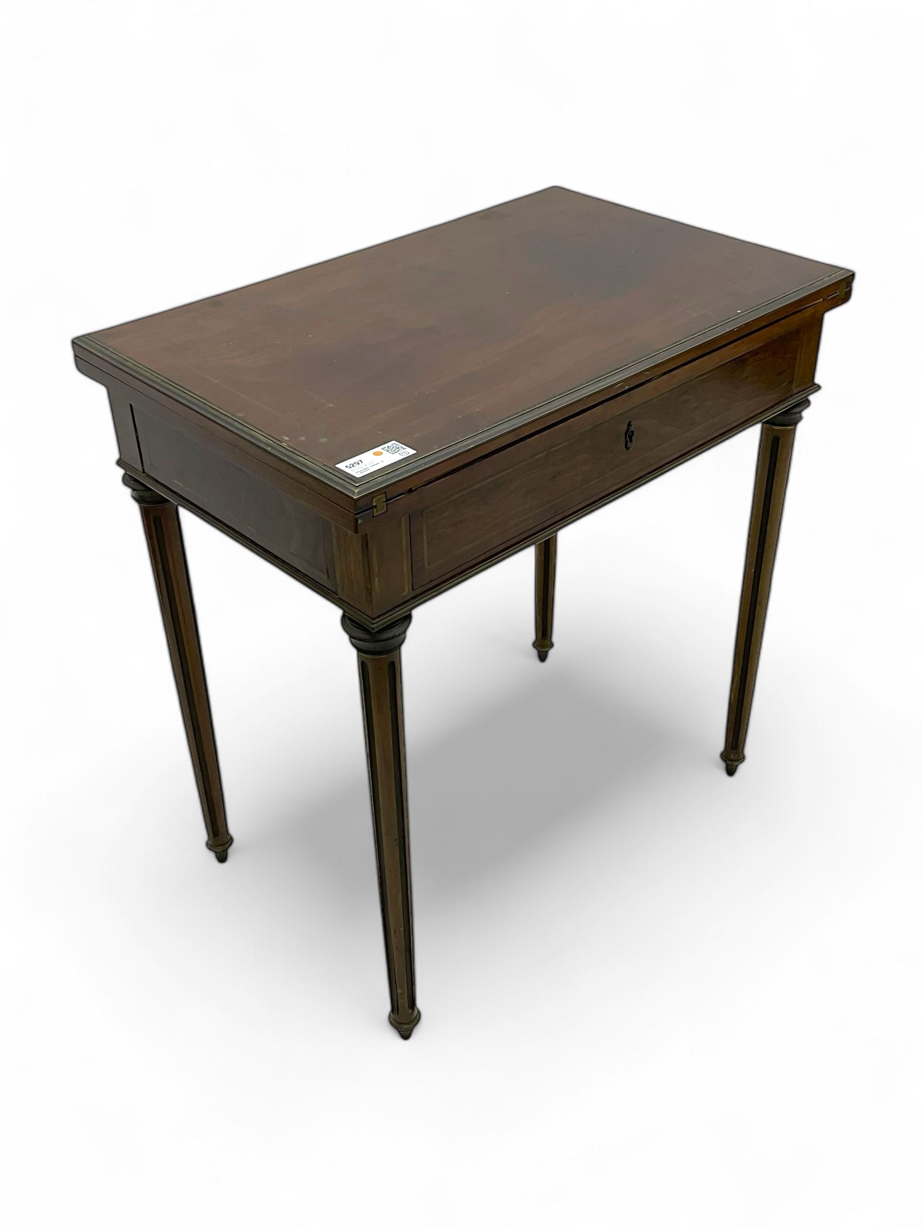 Mid-20th century French design mahogany fold-over card table, the top opens to reveal inset leather playing surface, the drawer fitted with inset writing surface, on turned and fluted supports with brass inlay and fittings