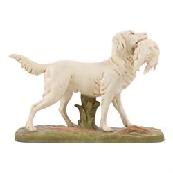 Royal Dux model of a hunting dog, with bird in mouth, upon gilt and green rustic base, mar...