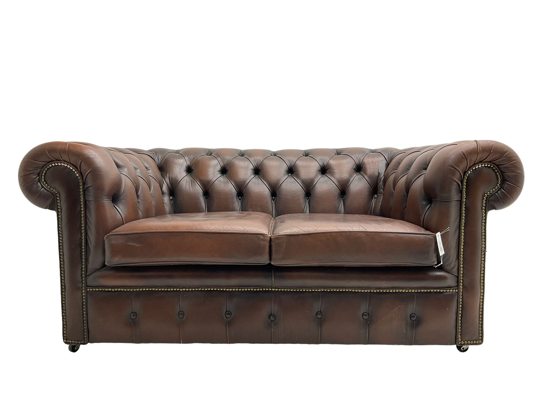 Chesterfield two seat sofa, upholstered in brown buttoned leather