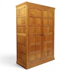 Beaverman - oak double wardrobe, enclosed by twin multi-panelled doors, Yorkshire Rose carved handles, the interior fitted with shelf and hanging rail, with signature carved beaver, by Colin Almack of Sutton, near Thirsk