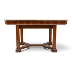 Art Deco walnut extending dining table, book-matched veneered shaped top, raised on cluster-column supports, united by stretchers, additional leaf extends to 185cm  