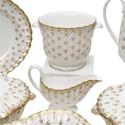 Spode Fleur de Lys tea and dinner service for ten, comprising dinner plates, side plates of graduating sizes, bowls, twin handled soup bowls, three covered dishes, sauce boat and saucer, two serving dishes, open serving dish, teapot, coffee pot, milk jug, covered sucrier, cake plate, vase, jardiniere, cups and saucers