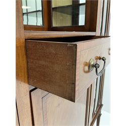 Edwardian inlaid mahogany display cabinet with ‘Shepard, Bennington & Co. Doncaster’ makers plaque, central bevel edge mirror flanked by two glazed doors enclosing two lined shelves, single drawer above cupboard on square tapering supports with spade feet