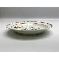 18th century Worcester Chinese Family pattern plate, circa 1765, of circular form with scalloped rim, the dished centre decorated in polychrome enamels with figures gathered around a table, within iron red line and dot borders, D19cm