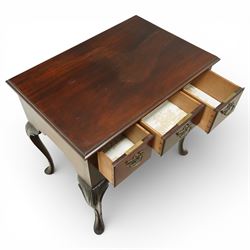 Early 20th century Irish mahogany lowboy, rectangular moulded top over three frieze drawers fitted with brass swan neck handles and escutcheons, shaped apron, raised on cabriole supports terminating in pad feet