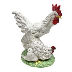 Italian pottery sculpture of a cockerel and hen, stood upon a green ground, H52cm