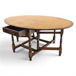Titchmarsh & Goodwin - 18th century design oak oval drop-leaf dining table with leather dining chairs, the table with drop leaves forming an oval top extending to 180cm, with drawer to either side, raised on turned supports with gateleg, the chairs comprising two carvers in tan leather and two side chairs in green and tan leather backs, brass studded trim with turned uprights and stretchers