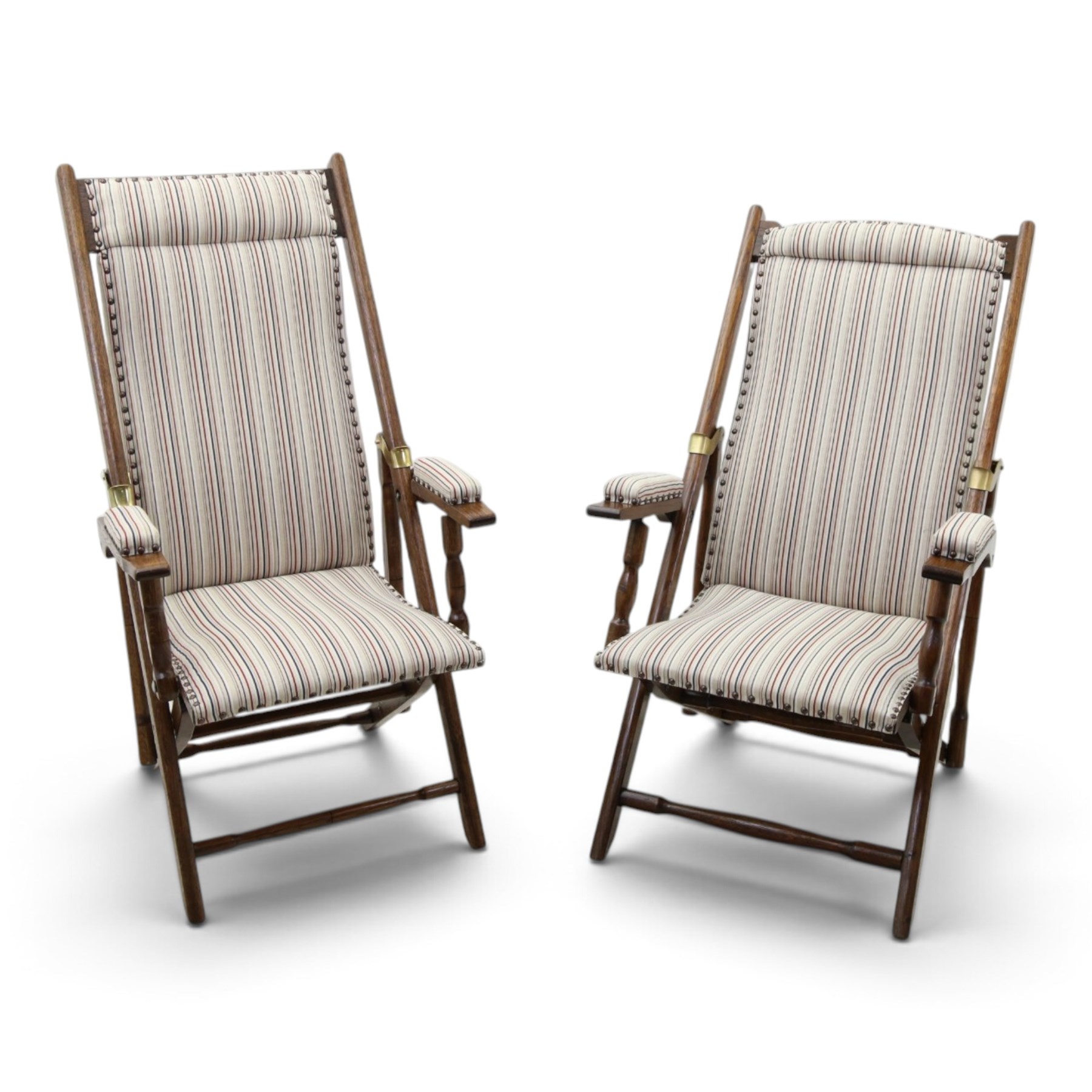 Pair of early 20th century oak framed garden reclining and folding deckchairs, high back and seat upholstered in striped fabric with padded armrests