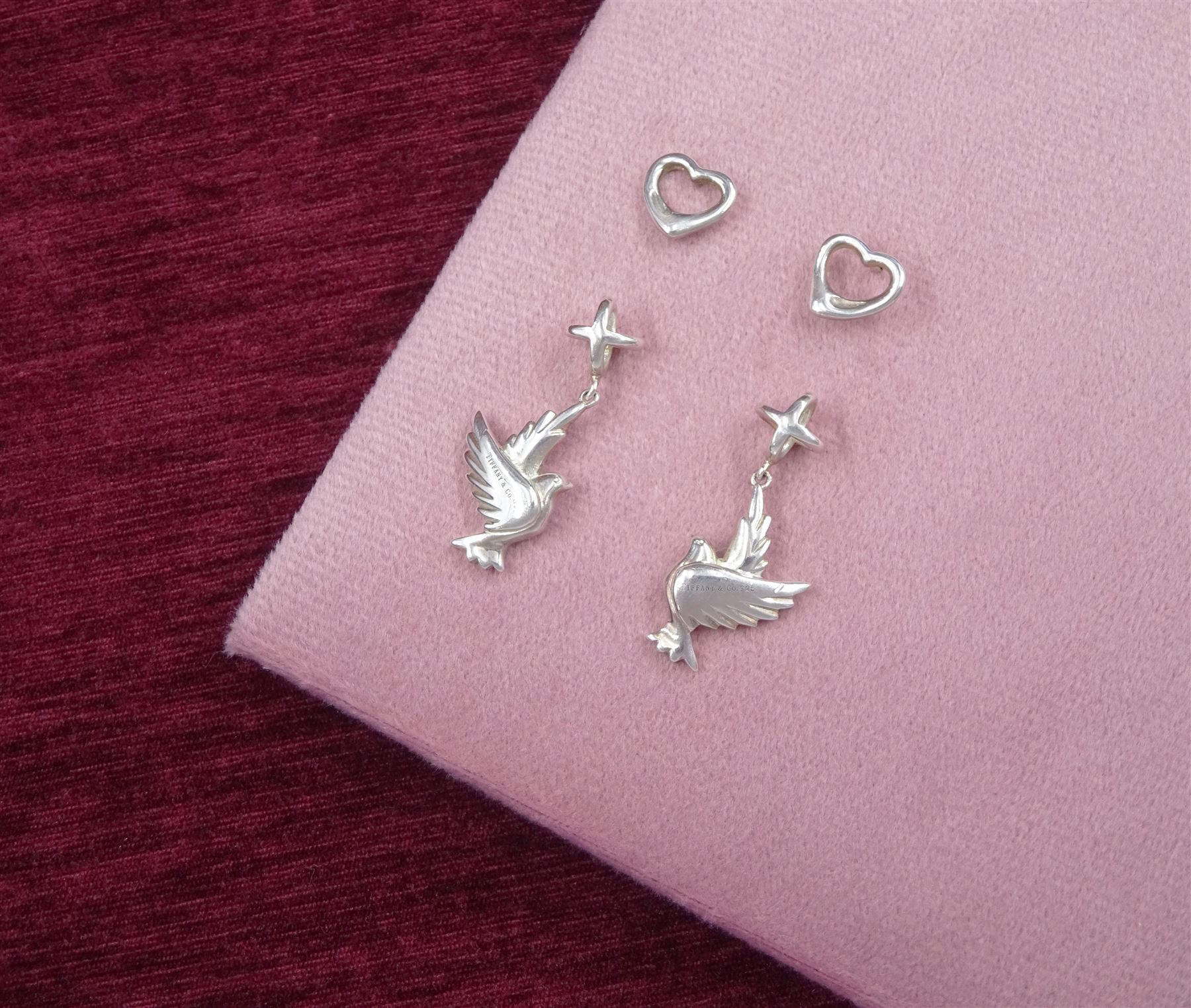 Tiffany & Co two pairs of silver stud earrings including pendant dove earrings designed by Paloma Picasso and heart earrings designed by Elsa Peretti