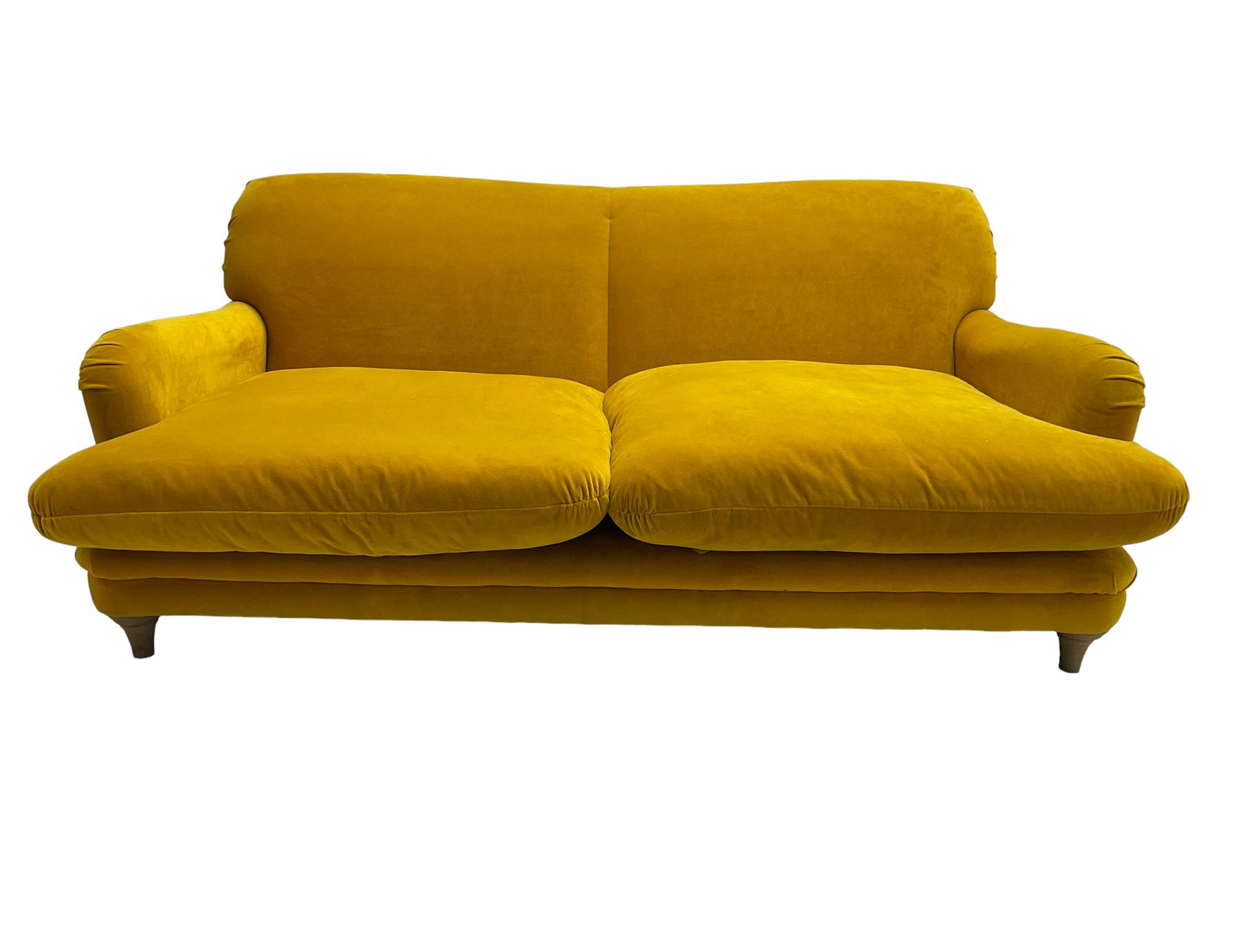 Loaf - large two seat 'Jonesy' sofa, upholstered in mustard velvet fabric with sprung back and loose seat cushions, raised on pale oak turned supports