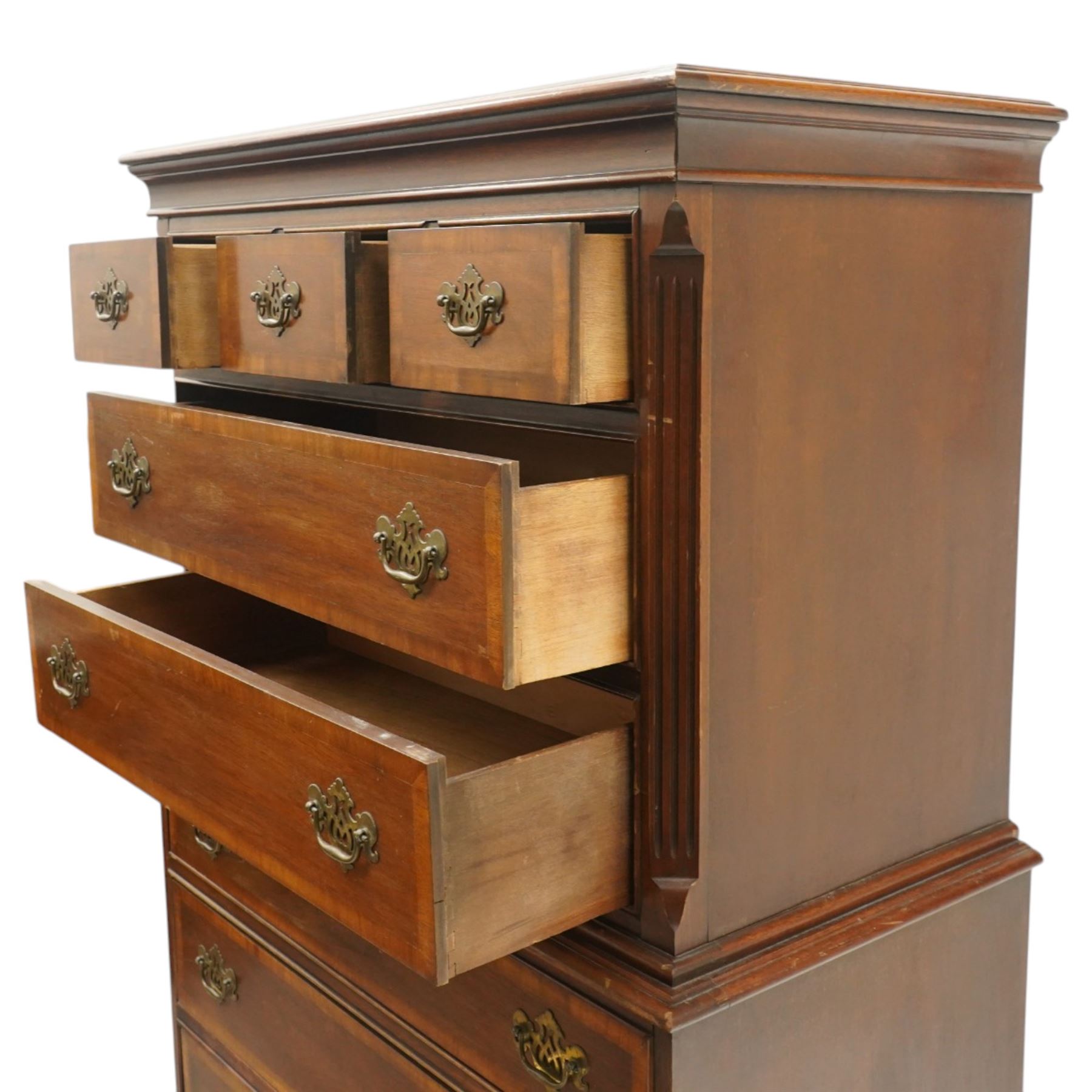 Georgian design mahogany chest on chest, moulded projecting cornice over three short and two long drawers, canted fluted front corners, lower section fitted with three long drawers, brass pierced backplate handles and escutcheons, on shaped bracket feet