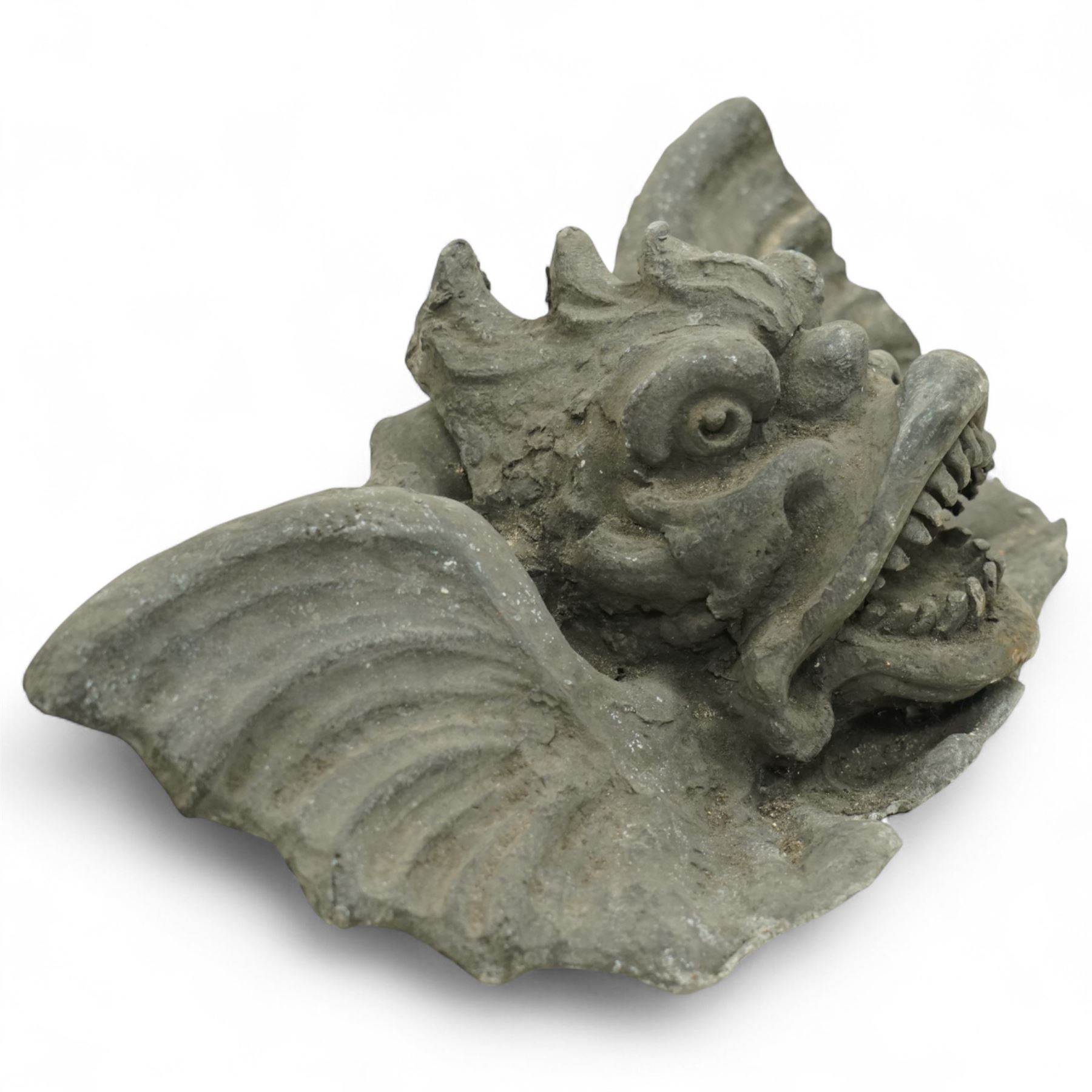 19th century cast lead fountain head with spout in the form of a grotesque fish, the mouth agape with rows of teeth, flanked by protruding fins 