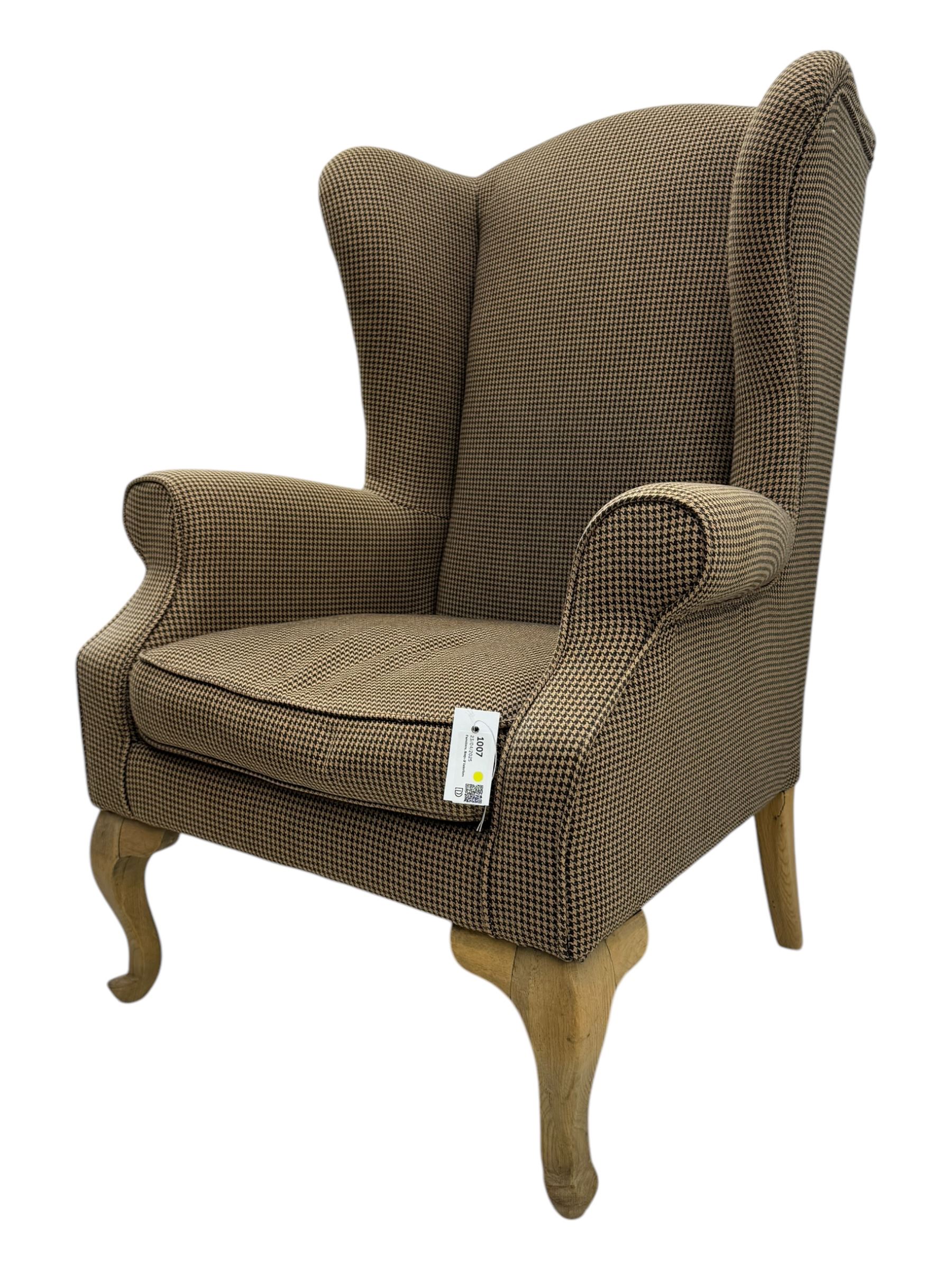 Hardwood-framed wingback armchair, upholstered in dog tooth pattern fabric, on cabriole supports 
