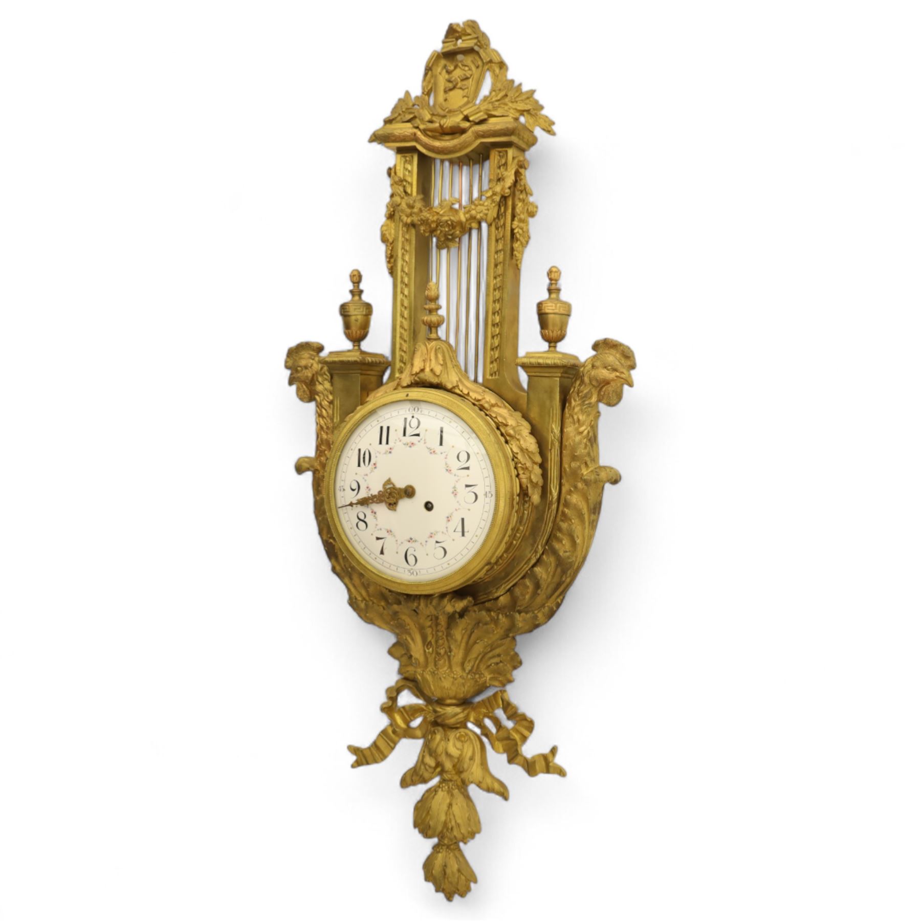 French- late 19th century cast brass and ormolu 8-day cartel wall clock, with a profusely decorated case comprising urn finials garland wreaths, ribbon bows and French cockerels, white enamel dial with minute track, Arabic numerals, garland swags and pierced gilt hands, twin train movement with a recoil anchor escapement and countwheel strike, striking the hours and half-hours on a bell. With pendulum and key.