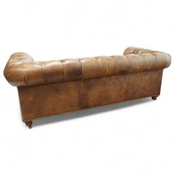 Timothy Oulton, Halo - Late 20th century brown leather Chesterfield settee, the upholstered frame with deep buttoning to back and arms, large scroll terminals with brass studwork, twin seat cushions, raised on castored legs