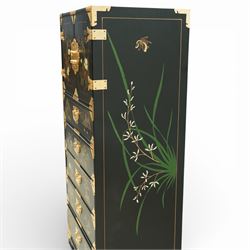 Japanese Shibayama style black lacquered curio chest, cupboard doors enclosing four short over two long fitted drawers, decorated in gilt with birds, flowers and landscape scenes, raised on gilt mounted bracket feet