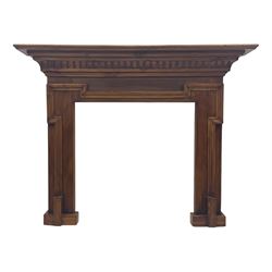 Victorian stained pine fire surround, projecting cornice with dentil moulding, panelled frieze and chamfered uprights on block supports