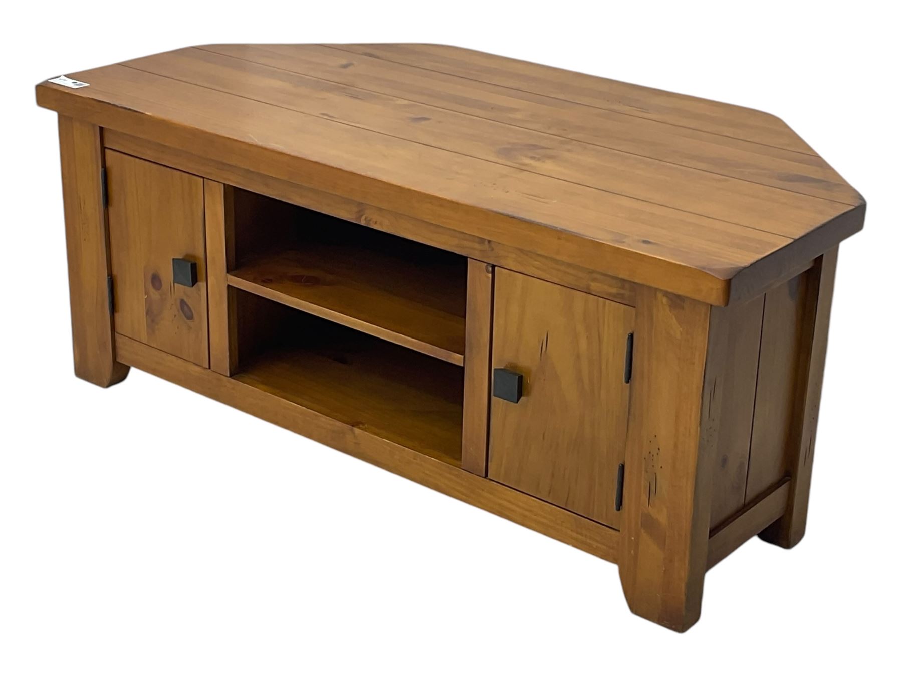 Contemporary mango wood television stand, wide planked surface and angled back corners, central shelving section flanked by twin cupboard doors with square pull handles, raised on stile supports