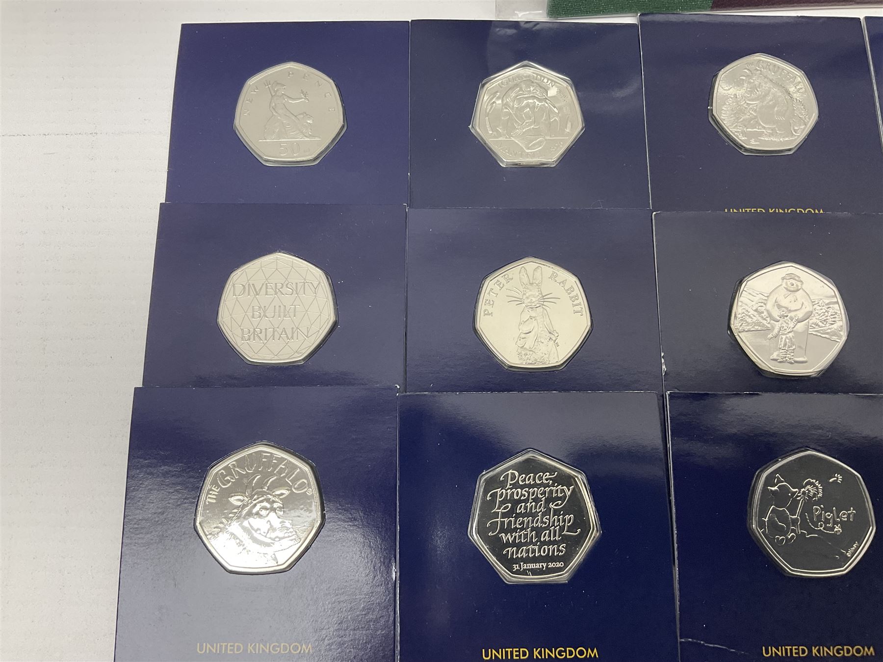 Mostly United Kingdom Queen Elizabeth II commemorative fifty pence coins, including 2019 'Gruffalo', 2020 'Iguanodon', 2022 'The Queen's Jubilee' etc, housed on cards, face value of UK coins approximately 20 GBP