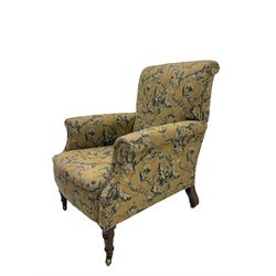 Victorian walnut armchair, upholstered in floral scroll patterned fabric, on turned front supports with brass castors