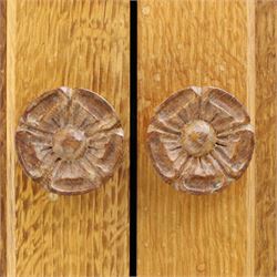 Lizardman - adzed oak media cabinet, adzed rectangular top above twin doors enclosing a shelved interior, above a fall front drawer, Yorkshire Rose carved handles, raised on castors, with carved lizard signature, by Derek Slater of Crayke  