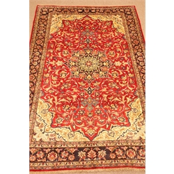  Nafaf Abad red ground rug, central medallion on floral field, repeating border, 350cm x 229cm  