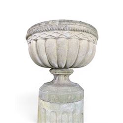 Four 20th century good quality weathered cast stone pedestal urns, circular lobed bowls with rope twist and lattice border, raised on squat base with fluted columns