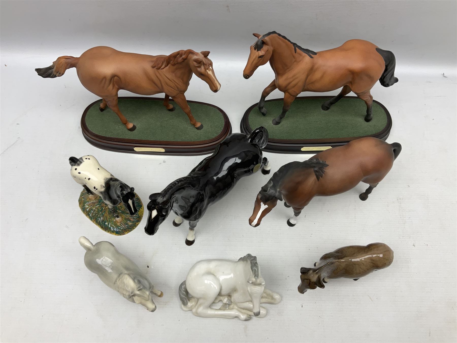 Collection of Beswick horse figures, to include Red Rum on a wooden plinth,  Lammtarra on oval plinth, Morgan Horse Black and three others, together with Royal Daulton Appaloosa Foal and a USSR horse