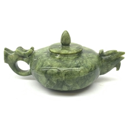 A carved jade teapot, the spout modelled as the head of a bird, the handle modelled as a stylised dragons head, H7.5cm. 