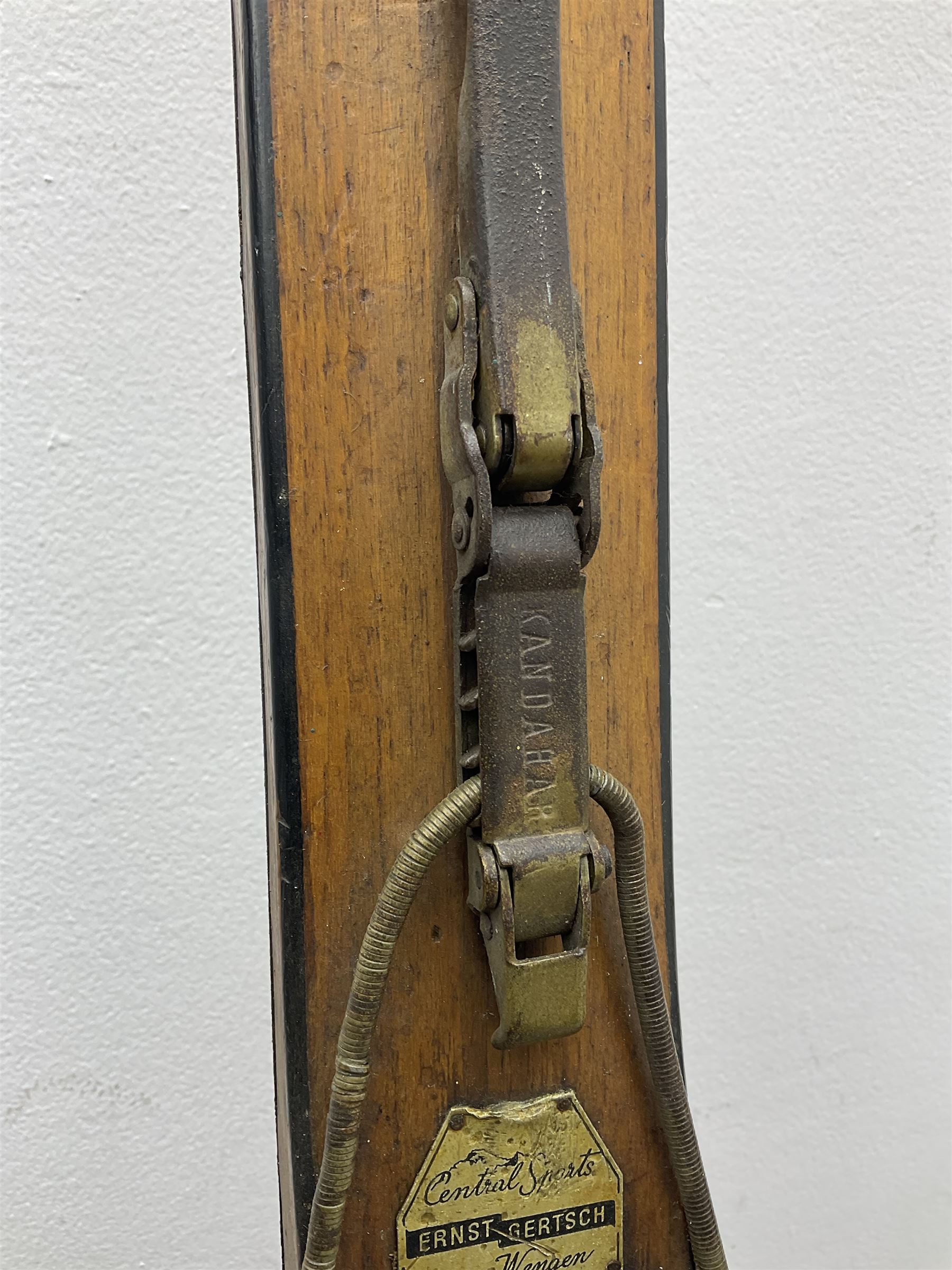 Pair of 1930s wooden skis, with painted metal runners beneath stamped Attenhofer, with retailers label for Ernst Gertsch Central Sports, L206cm