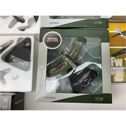 Fourteen die-cast models of aircraft including four Oxford Aviation, two Military Giants of the Sky, two Ixo Models, Corgi Warbirds Messerschmitt, Atlas Editions Spitfire and Messerschmitt, two Hobby Master etc; and two die-cast models of tanks; all boxed (16)