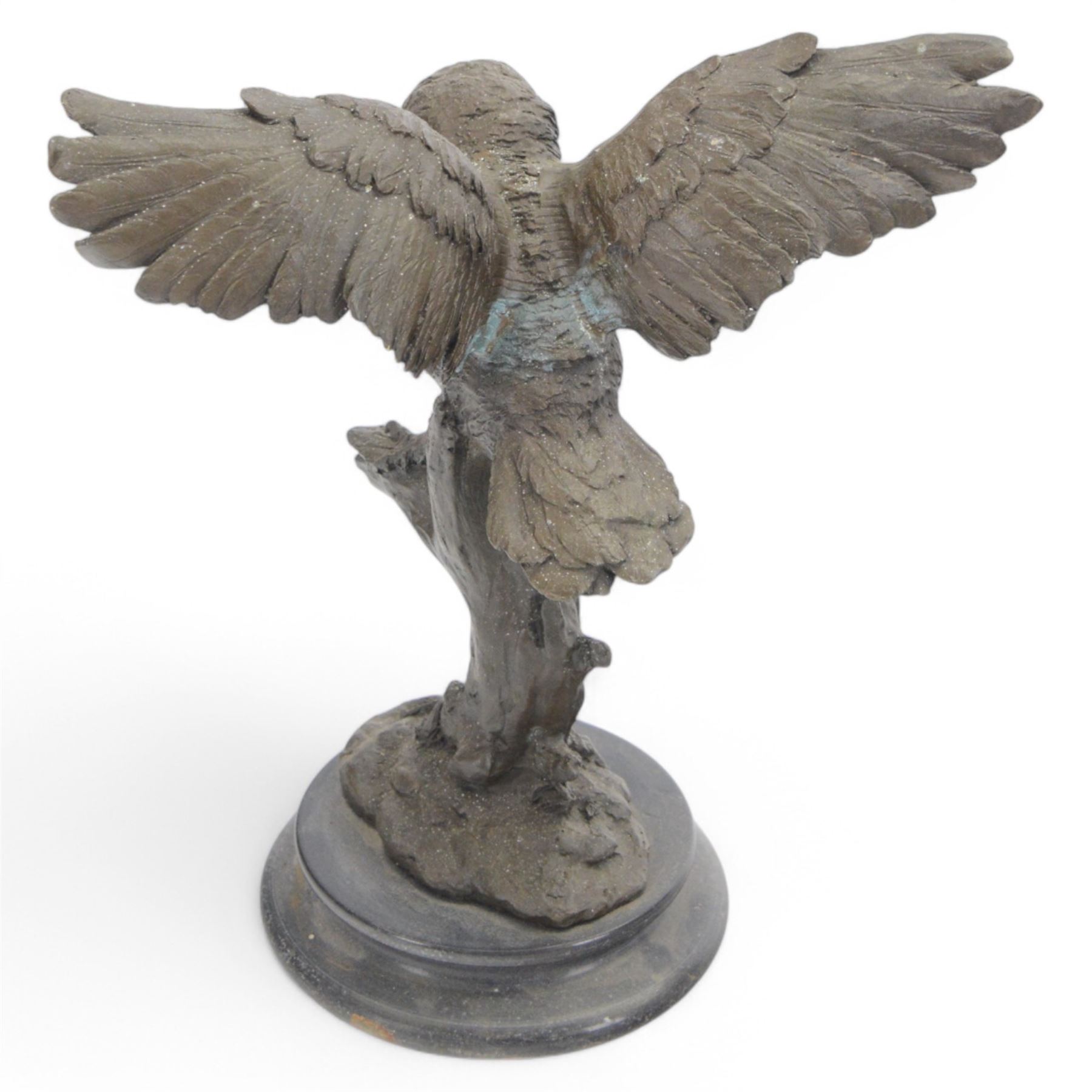 Bronzed figure of an owl taking flight, upon a circular hardstone base, H29cm