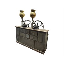 Cabinet with multiple drawers and cupboards mounted with two industrial coffee grinders with large flywheels and brass coffee reservoirs, early 20th century 